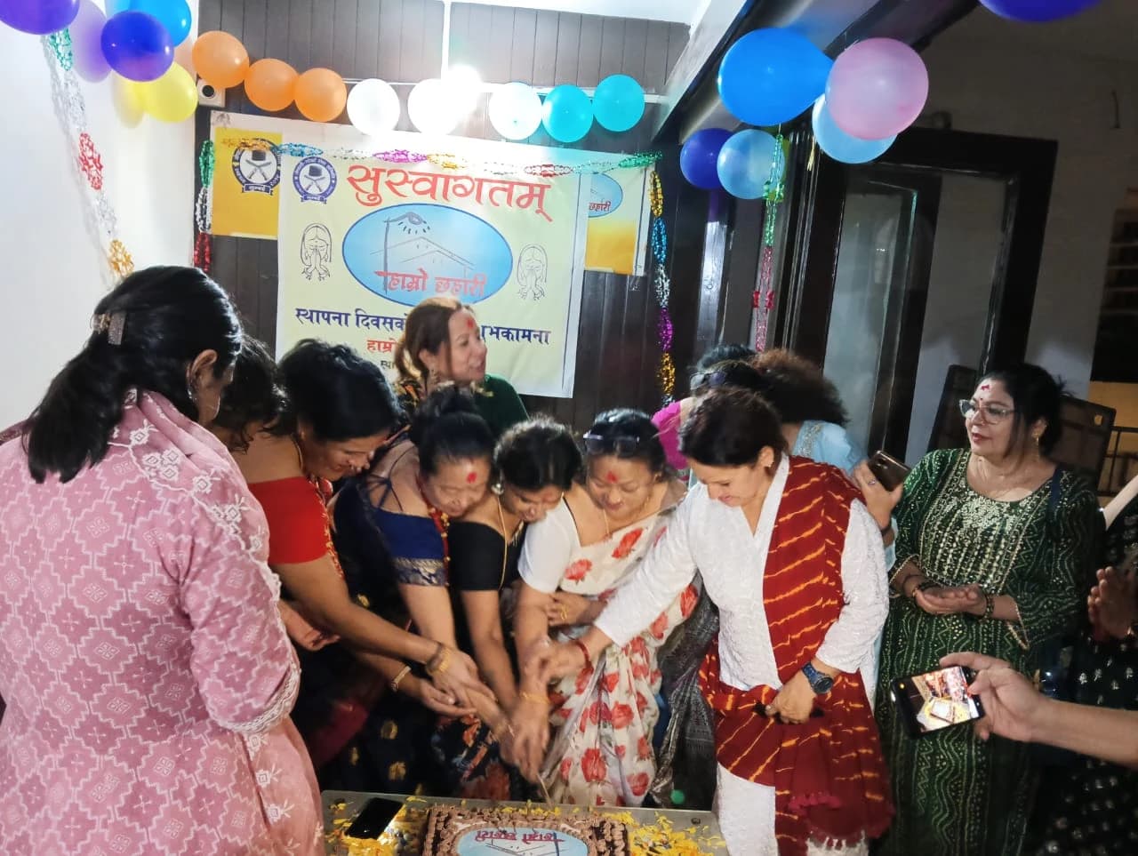 Sthapana Diwas · women members cutting the celebration cake