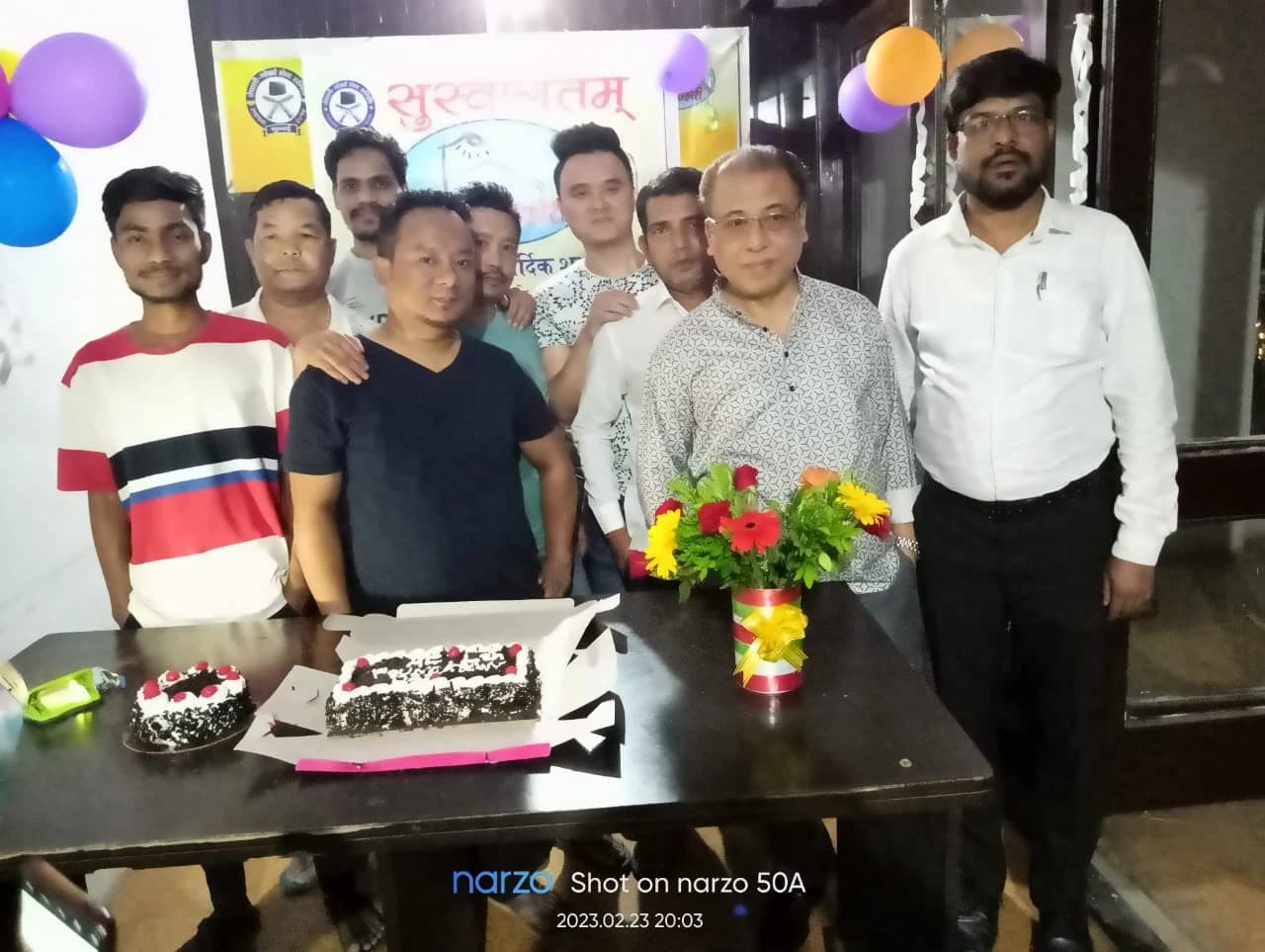 Sthapana Diwas · men members with celebration cake