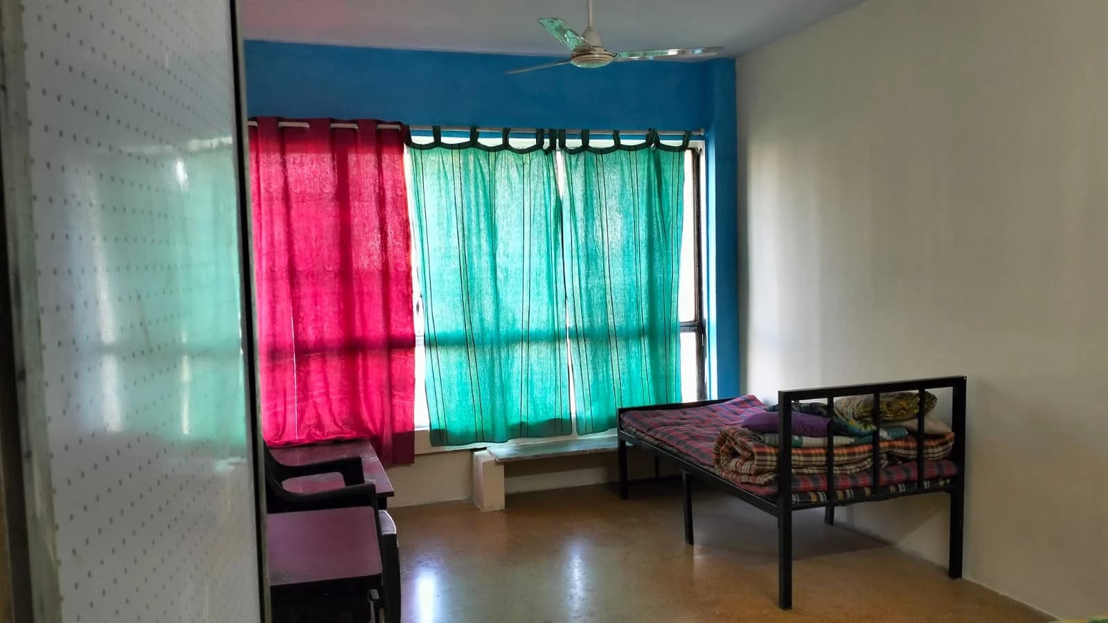 Mumbai ashram · airy single room with ceiling fan