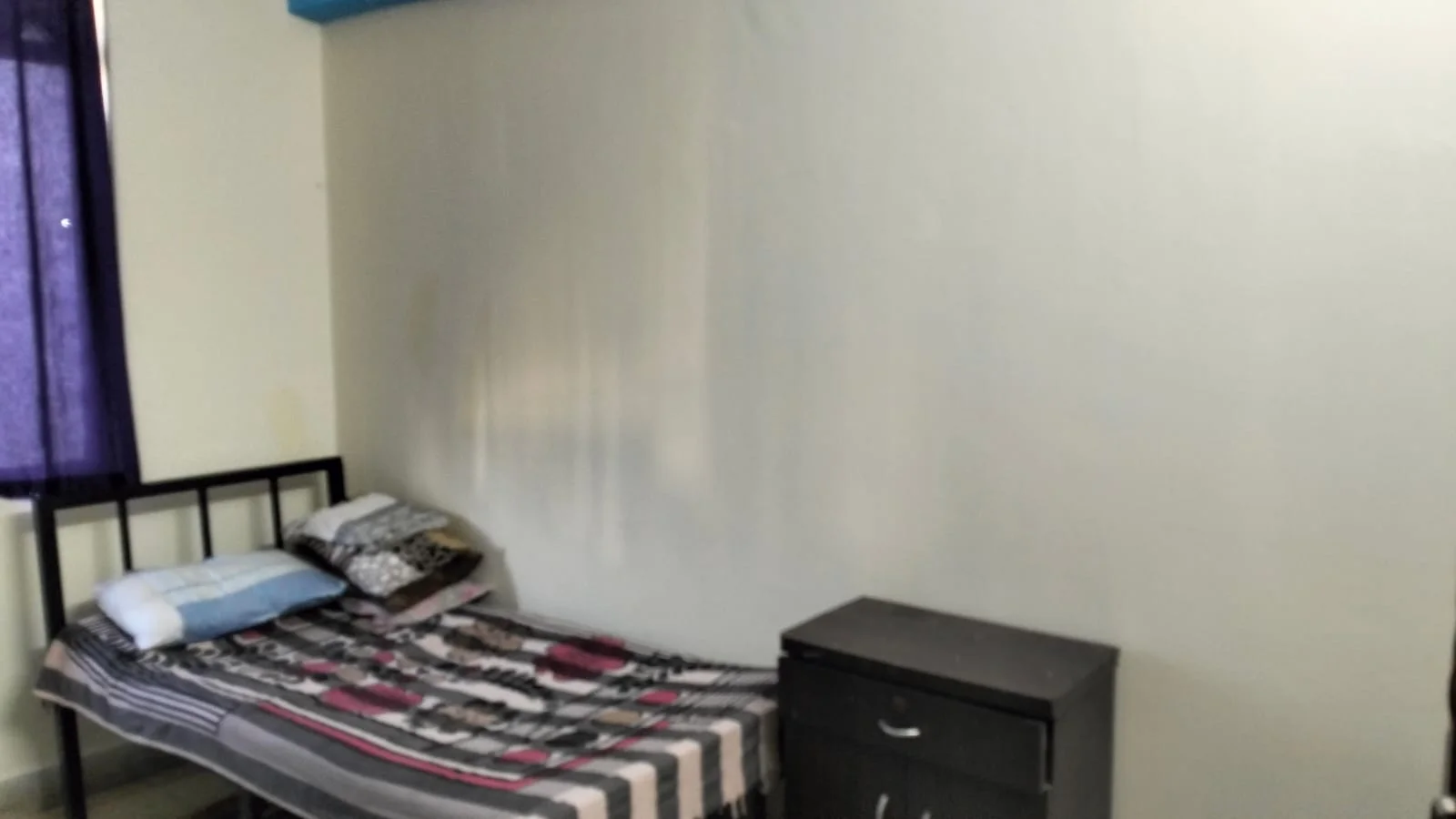 Mumbai ashram · single bed with side cabinet